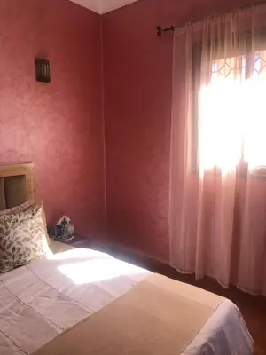 a bedroom with a bed and a window at Ghazaly house in Marrakech