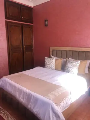 a bedroom with a large bed with white sheets at Ghazaly house in Marrakech
