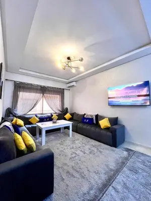 a living room with a couch and a table at séjournée chez mayaa in Marrakech
