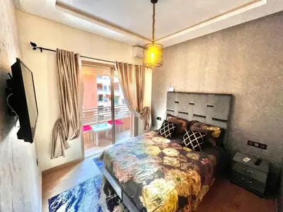 a bedroom with a bed and a television in it at séjournée chez mayaa in Marrakech