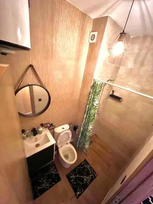 a bathroom with a toilet and a sink and a mirror at séjournée chez mayaa in Marrakech
