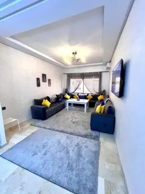 a living room with a couch and a table at séjournée chez mayaa in Marrakech