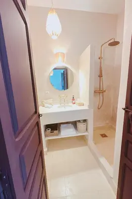 a bathroom with a sink and a mirror at Riad Solila, Fabuleux riad avec 4 Suites, Piscine Chauffée et Rooftop - 5 min de Jamaa El Fna in Marrakech