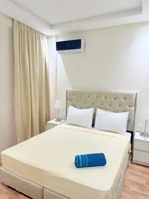 a bedroom with a bed with a blue pillow on it at N47 Confortable Près De Gueliz FAMILY in Marrakech