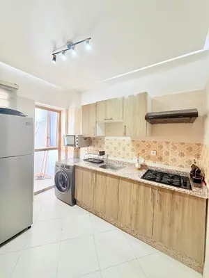 a kitchen with a sink and a refrigerator at N47 Confortable Près De Gueliz FAMILY in Marrakech