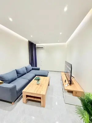 a living room with a blue couch and a table at N47 Confortable Près De Gueliz FAMILY in Marrakech