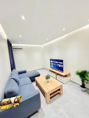 a living room with a blue couch and a coffee table at N47 Confortable Près De Gueliz FAMILY in Marrakech