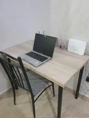 a laptop computer sitting on top of a wooden table at In Gueliz, Chic and Ethnic with a palm view in Marrakech
