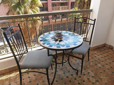 a table and two chairs on a balcony at In Gueliz, Chic and Ethnic with a palm view in Marrakech