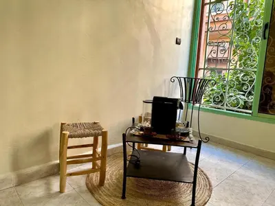 a room with a table and a chair and a window at Modern & Chic Duplex Near The Center, Brand New in Marrakech