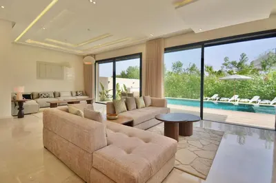 a living room with a couch and a pool at Villa Luxe 5 Suites & Piscine in Marrakech