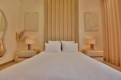 a bedroom with a large white bed with two lamps at Villa Luxe 5 Suites & Piscine in Marrakech