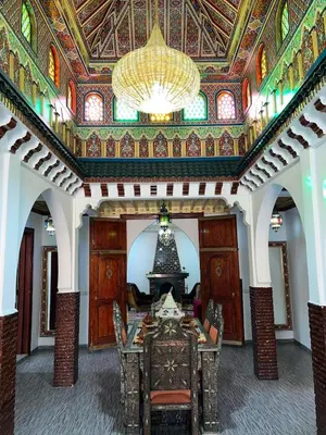 a dining room with a table and a ceiling at Riad For families and groups in Marrakech