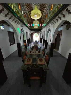 a large room with a long table and chairs at Riad For families and groups in Marrakech