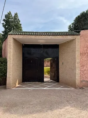 an empty garage with a black gate in it at Riad For families and groups in Marrakech
