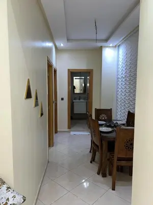 a dining room and kitchen with a table and chairs at Nice apartment in Marrakech