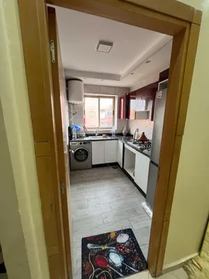 a small kitchen with a sink and a refrigerator at Nice apartment in Marrakech