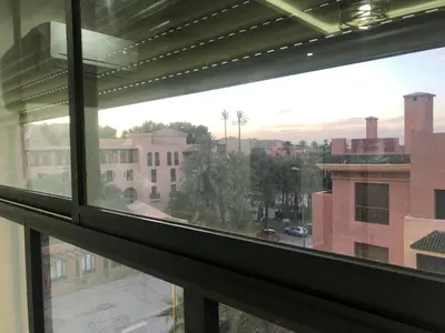 a view of a city from a window at APPARTEMENT MODERNE AU CENTRE m in Marrakech