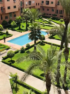 an aerial view of a resort with a pool and palm trees at ELEGANT APARTMENT DOWNTOWN m in Marrakech