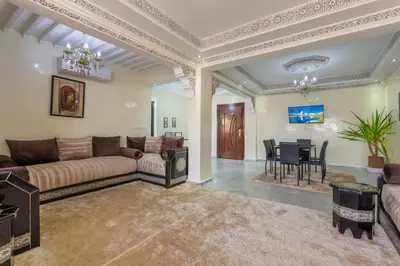 a living room with a couch and a dining room at ELEGANT APARTMENT DOWNTOWN m in Marrakech