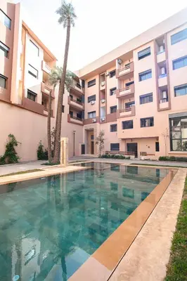 a swimming pool in front of a building at Signature Suite Private Pool in Marrakech