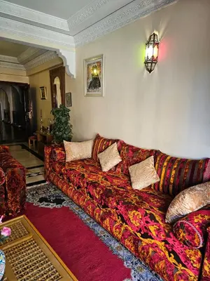 a living room with a couch with pillows on it at Warda-A-31 Rue Abi Hanifa in Marrakech