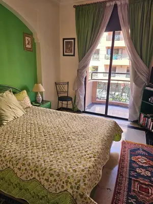 a bedroom with a bed and a large window at Warda-A-31 Rue Abi Hanifa in Marrakech