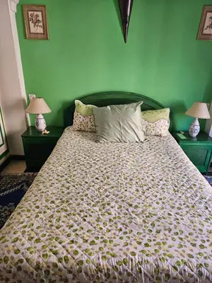 a bedroom with a large bed with two lamps at Warda-A-31 Rue Abi Hanifa in Marrakech