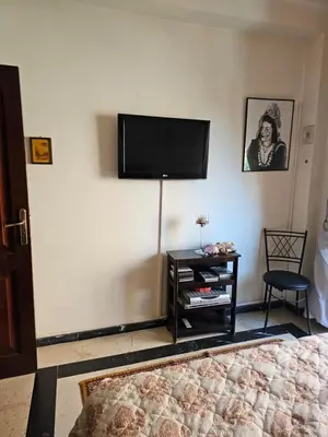 a living room with a flat screen tv on the wall at Warda-A-31 Rue Abi Hanifa in Marrakech