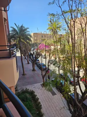 a view of a street with trees and a building at Warda-A-31 Rue Abi Hanifa in Marrakech