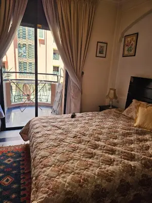 a bedroom with a large bed and a balcony at Warda-A-31 Rue Abi Hanifa in Marrakech