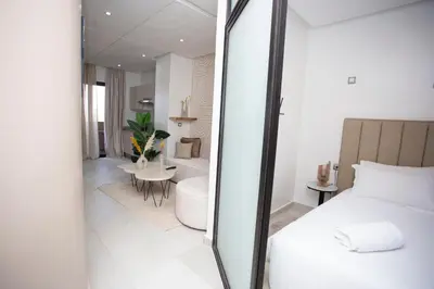 a bedroom with a bed and a bathroom with a tub at Smart Loft in Marrakech