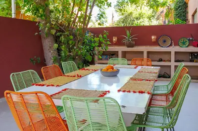 a white table with chairs and a bowl of oranges on it at Villa Dar Cactus piscine chauffée in Marrakech