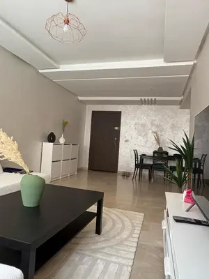 a living room with a couch and a table at Appartement Vue sur piscine in Marrakech