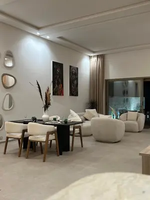 a living room with a couch and a table and chairs at Villa Tazinsky in Hbl Hmid