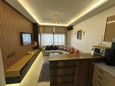 a living room with a couch and a table at Stylish Apartment with Pool in Central Location Near Gueliz and Medina in Marrakech