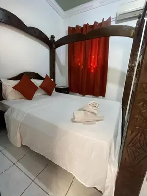 a bedroom with a bed with a red curtain at Riad Zitoune in Marrakech