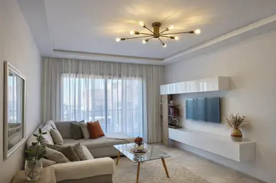 a living room with a couch and a tv at Luxury apartment and free parking in Marrakech