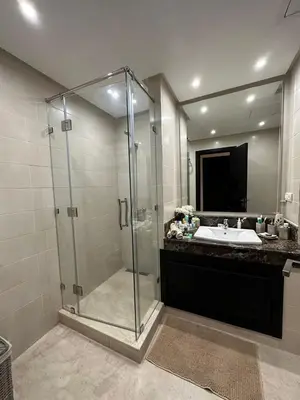 a bathroom with a glass shower and a sink at Luxury apartment and free parking in Marrakech