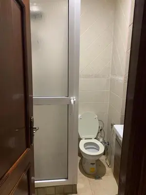 a small bathroom with a toilet and a sink at Asmae in Marrakech