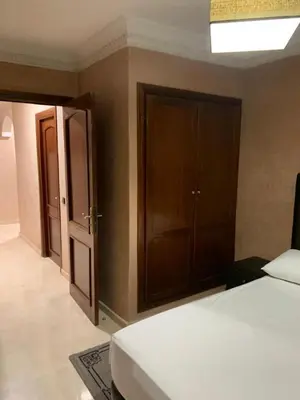 a bedroom with a bed and an open door at Asmae in Marrakech
