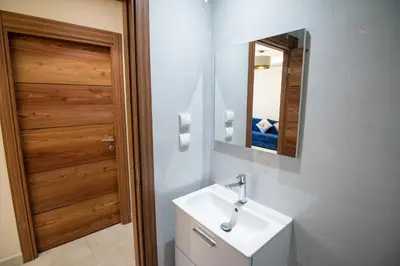 a bathroom with a white sink and a mirror at Luxury 2-Bedroom Apartment with Balcony - Heart of Gueliz in Marrakech