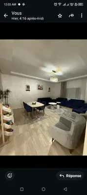 a living room with a couch and a table at Spacieux appartement familial 2 in Marrakech