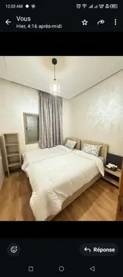 a bedroom with a large white bed with a window at Spacieux appartement familial 2 in Marrakech
