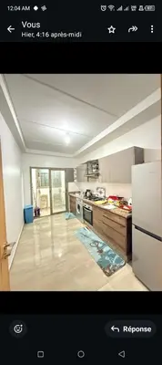 a view of a kitchen with a stove top oven at Spacieux appartement familial 2 in Marrakech