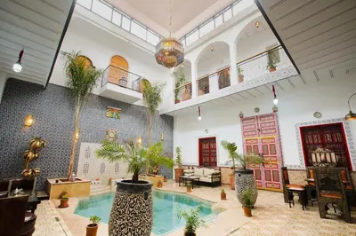 a large room with a swimming pool with plants at Riad Dar Mima Hnina - Your Traditional and Private haven of peace, 2 pools, 10' from airport in Marrakech