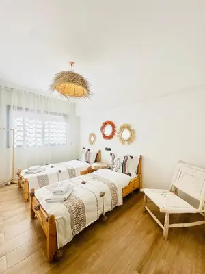 a room with three beds and a couch at Charmant Appartement 2 Room Wifi Marrakech in Marrakech