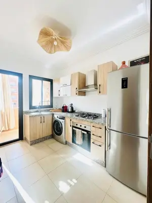 a kitchen with a stainless steel refrigerator and a dishwasher at Charmant Appartement 2 Room Wifi Marrakech in Marrakech