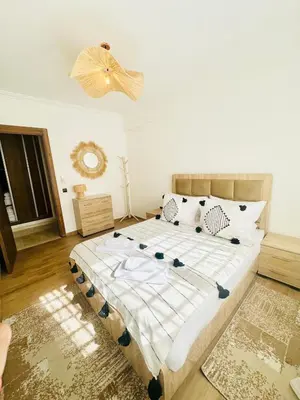a bedroom with a large bed in a room at Charmant Appartement 2 Room Wifi Marrakech in Marrakech