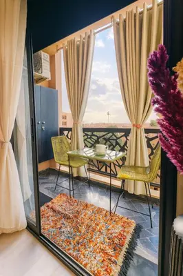 a view of a balcony with a table and chairs at Chic 1 bedroom WiFi apartment Marrakech in Marrakech